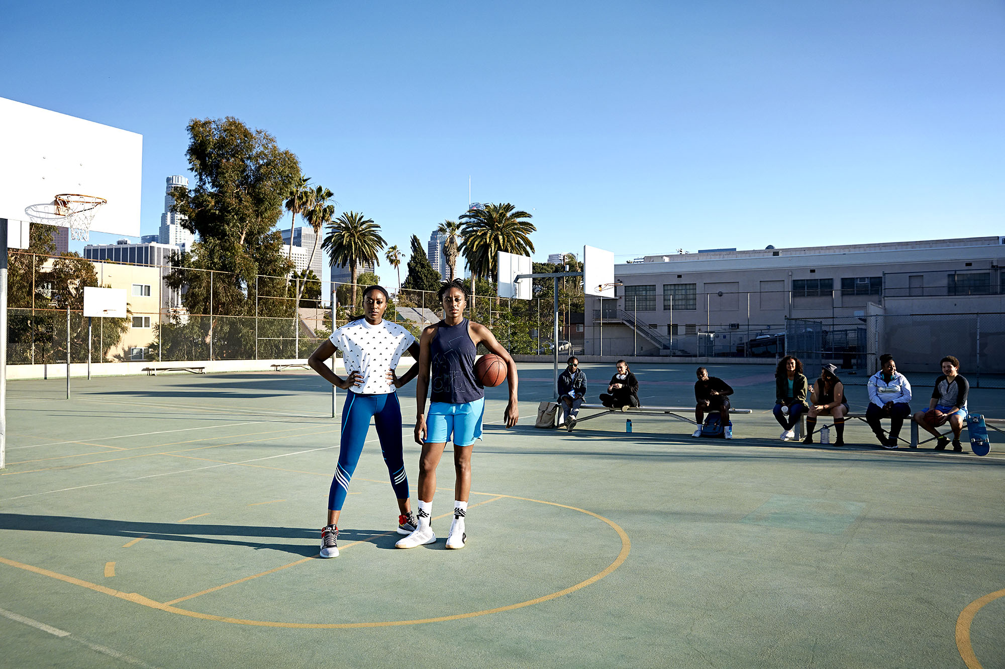 Women in Sports: Basketball Players Two women on a basketball court.